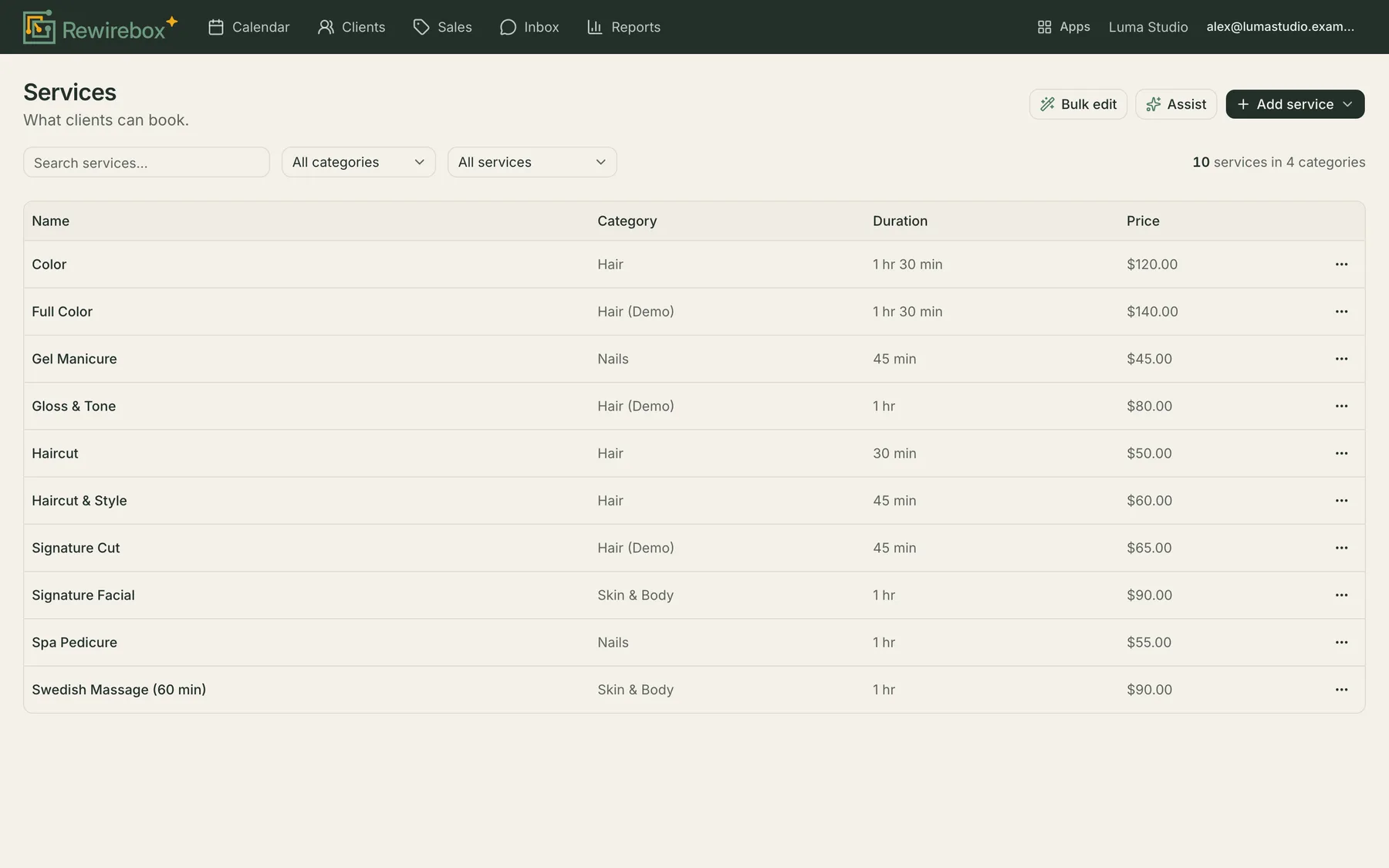 The RewireBox services screen: ten services in a table with their category, duration and price, above a search box and filters for category and status, with a summary reading ten services in four categories.