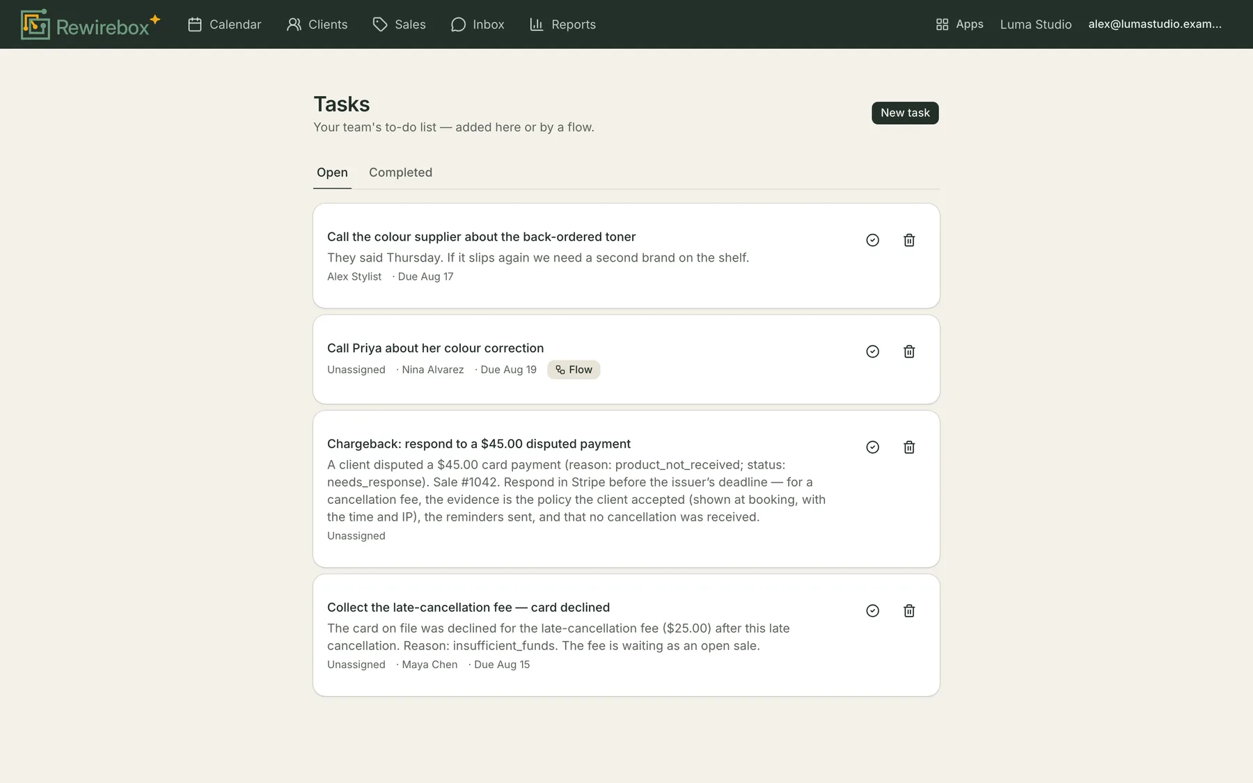 The Tasks screen with Open and Completed tabs: four cards, each a task title above its notes, with who it's assigned to, the client it's about and its due date, and a Flow badge on the one a flow created.